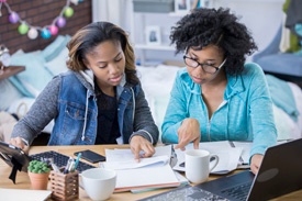 2 ladies reading at table