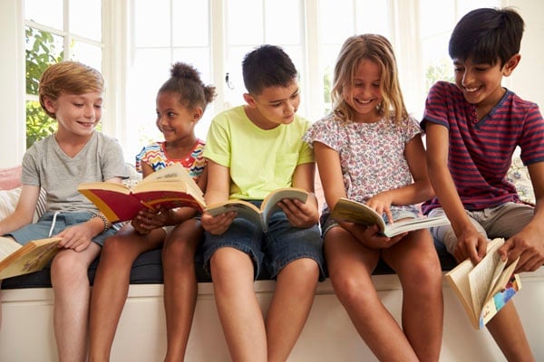 Childern reading by window